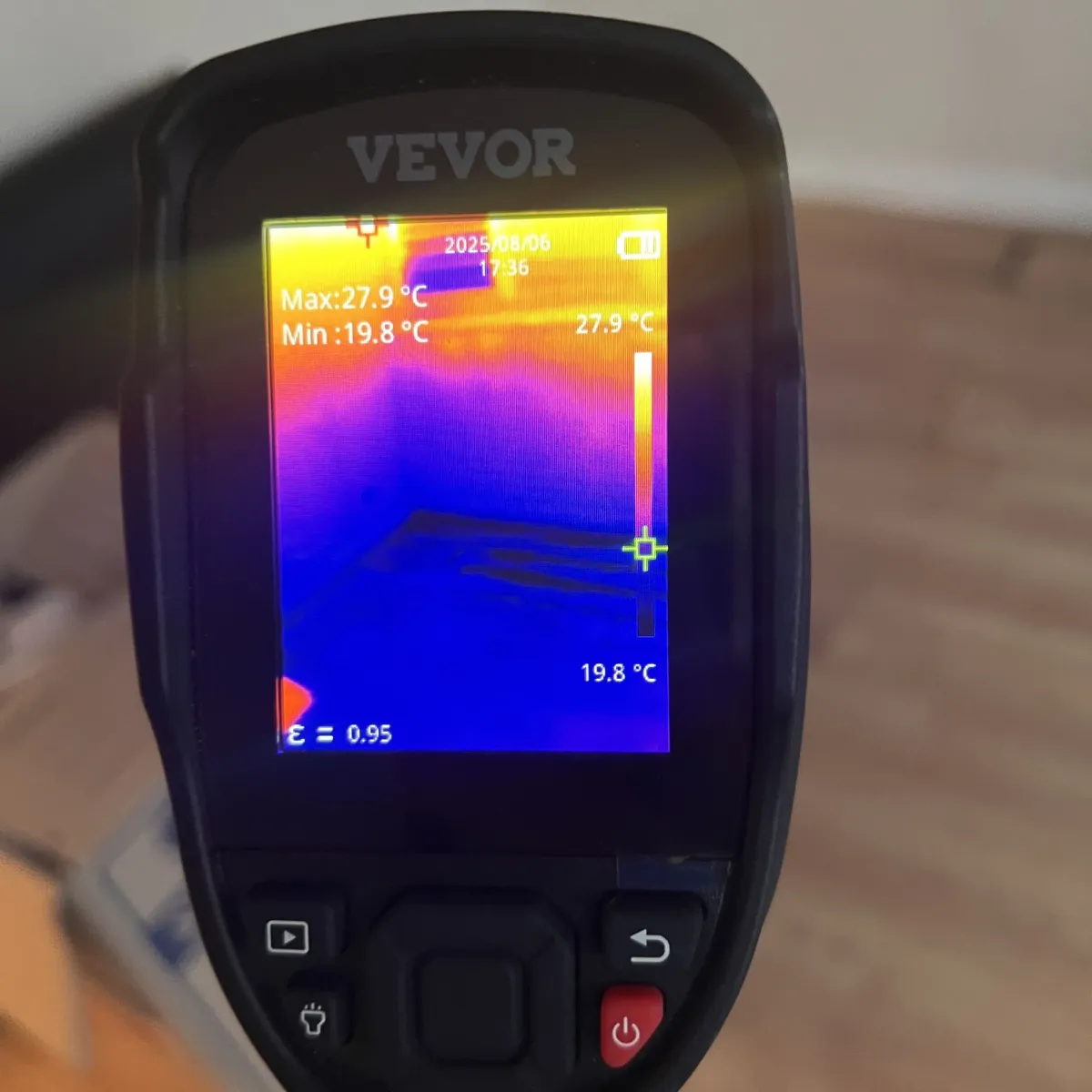 Moisture meter showing high readings during leak detection on interior wall