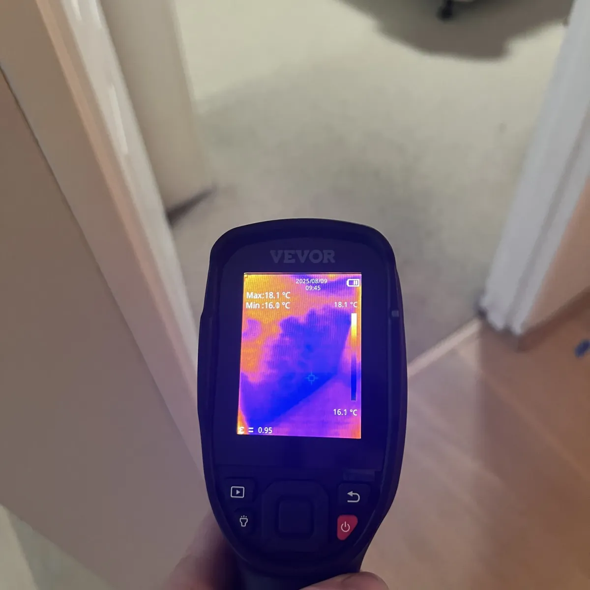 Moisture meter showing high readings during leak detection on interior wall