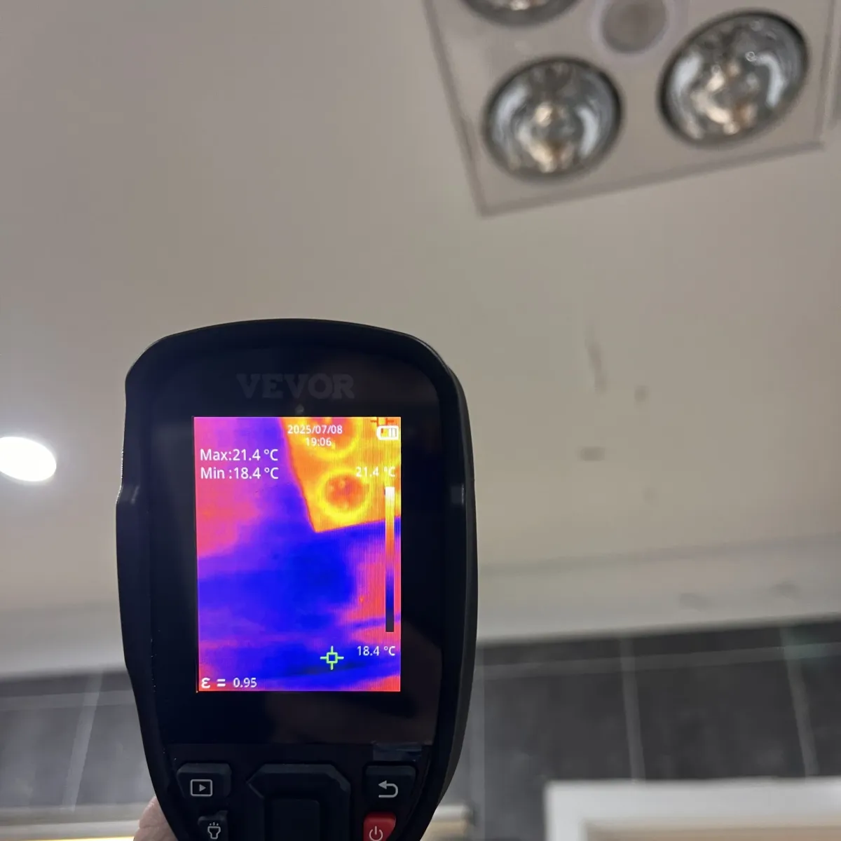 Moisture meter showing high readings during leak detection on interior wall