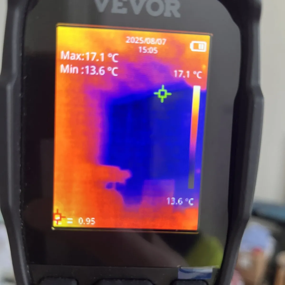 Moisture meter showing high readings during leak detection on interior wall