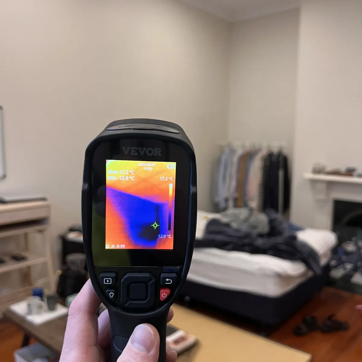 Moisture meter showing high readings during leak detection on interior wall