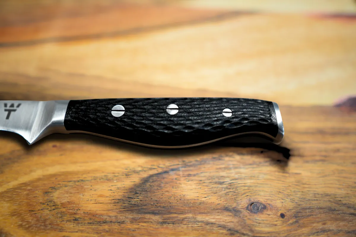 Detailed view of laser-shaped grip pattern on G10 fiberglass handle