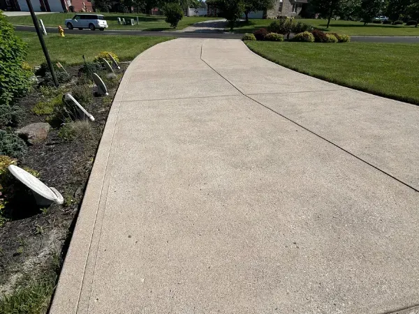 Clean concrete driveway after professional pressure washing service