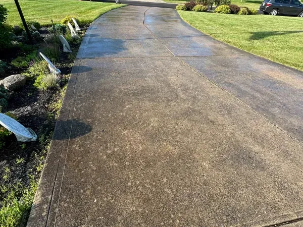 Dirty concrete driveway before professional pressure washing service