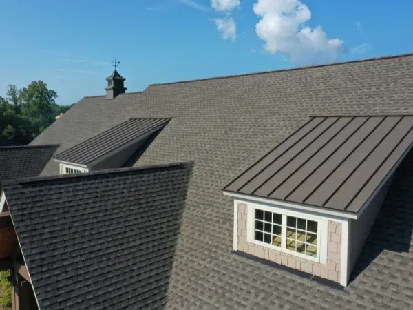 Clean roof with a combination of asphalt shingles and metal panels