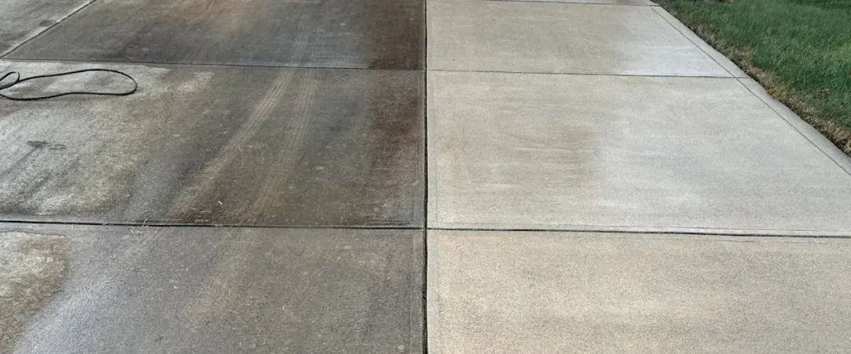 Side-by-side comparison of a driveway’s surface before and after pressure washing, showing dramatic stain removal.