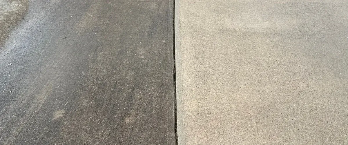 A close-up of a concrete surface split vertically, showing one side dirty and the other side clean.