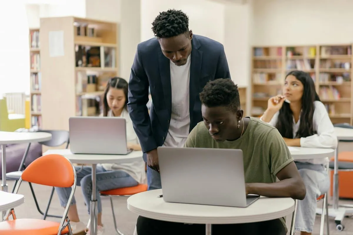 African American teacher helps high school student