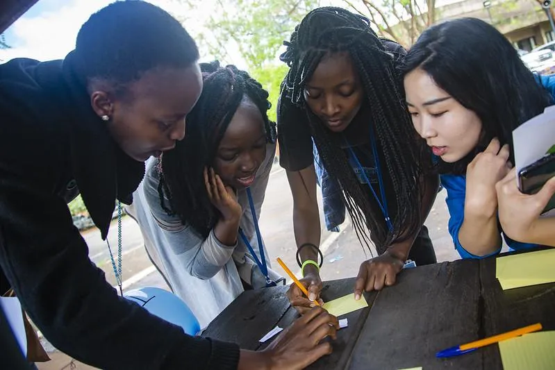 A man with a backpack is holding out his hands