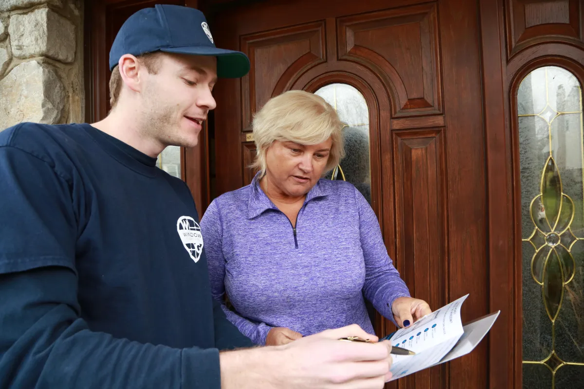 A black bench sitting next to a brick wall