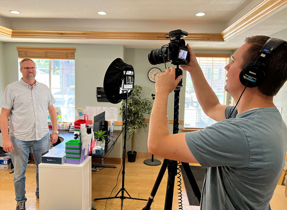 Man setting up a camera to film a shoot