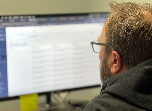 Man reviewing information on his computer screen