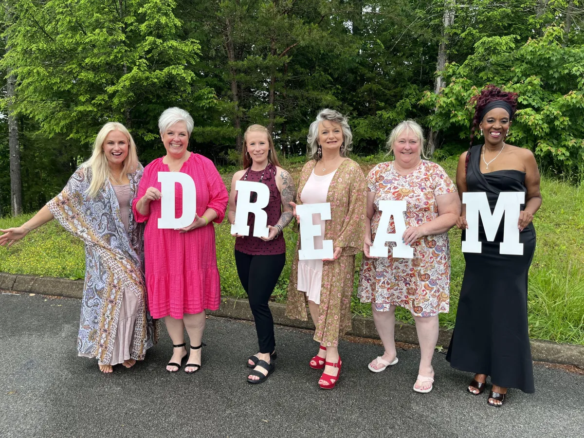 a small plant sprouts out of the pavement