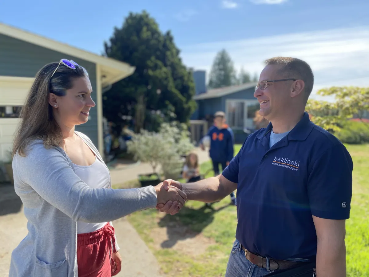 Bright, modern Seattle kitchen remodel with white cabinets, wood island, and stainless appliances
