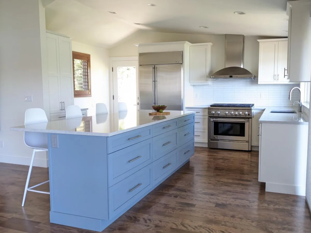 Kitchen after remodel with white shaker cabinets and island