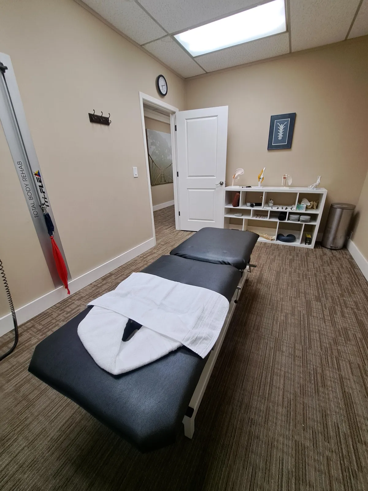 Modern chiropractic treatment room in Redmond featuring an advanced adjustment table at Back & Beyond Spine Care Clinic