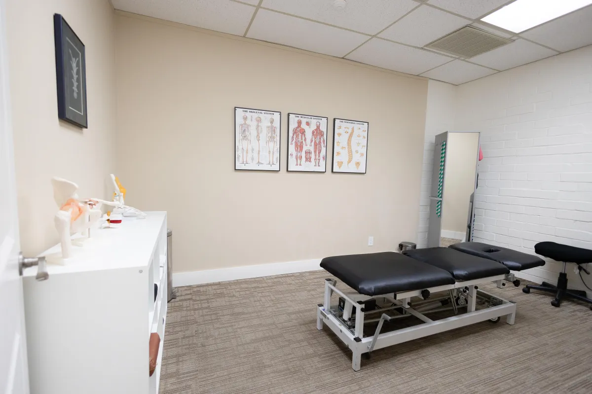 Inside Back & Beyond Spine Care Clinic in Redmond, showcasing chiropractic-themed furniture and wall art focused on athletic recovery and auto injury treatment