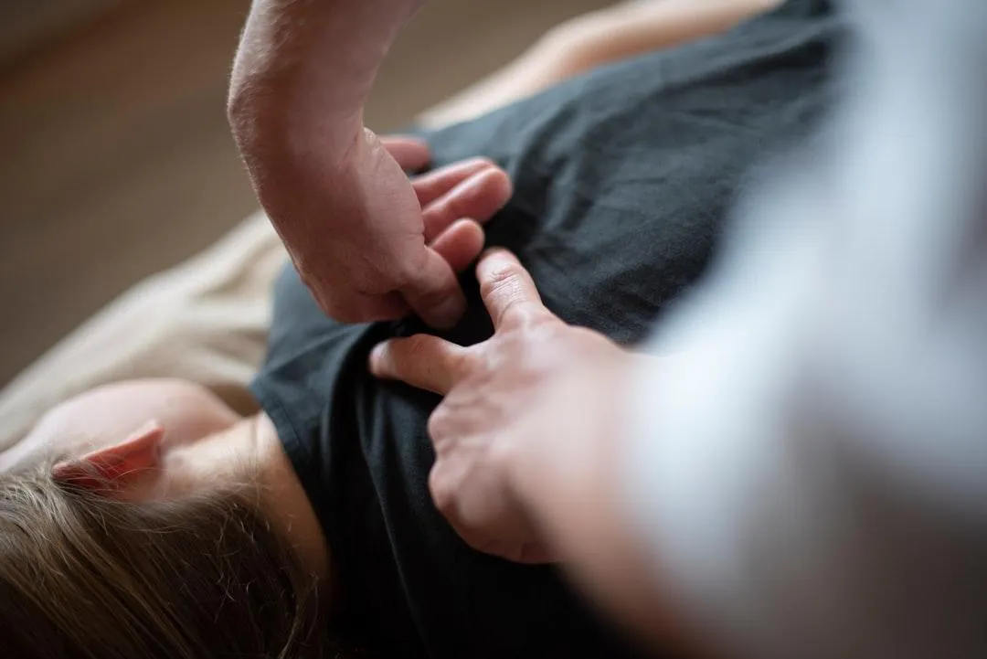 Female patient receiving professional spinal adjustment therapy at a chiropractic clinic