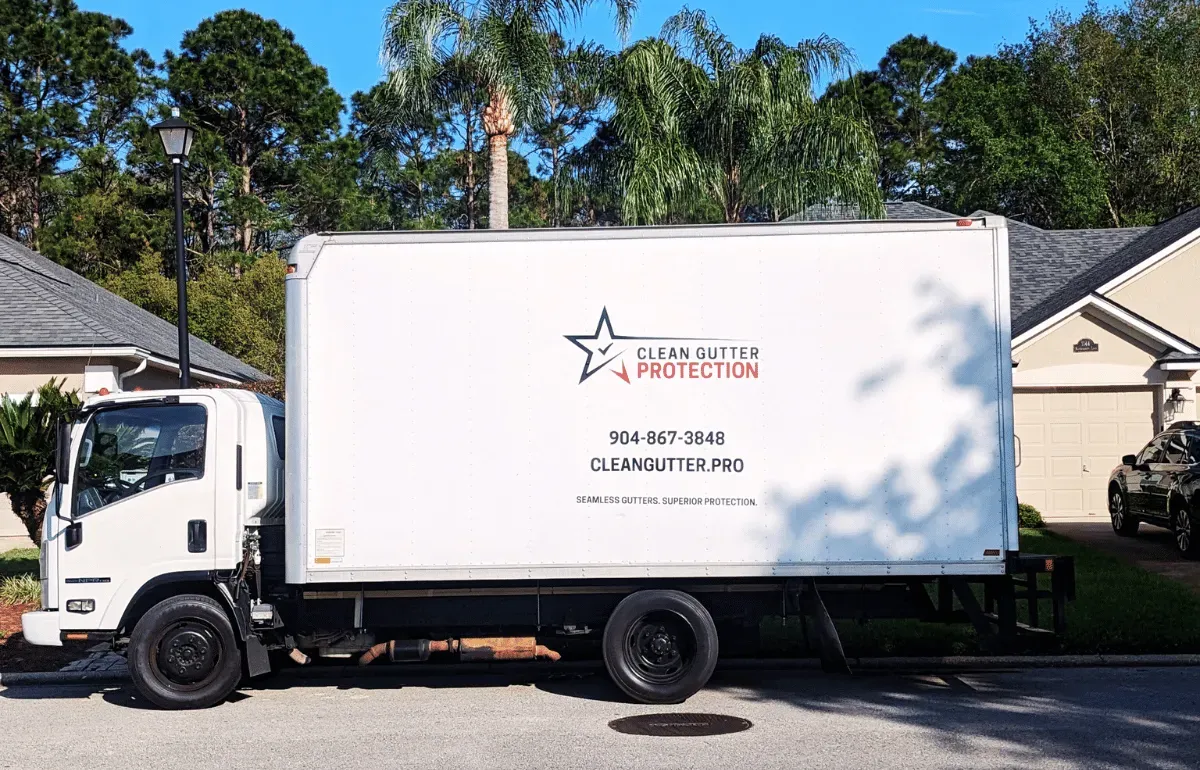 Clean Gutter Protection service truck parked in a residential neighborhood, prepared for seamless gutter installation.