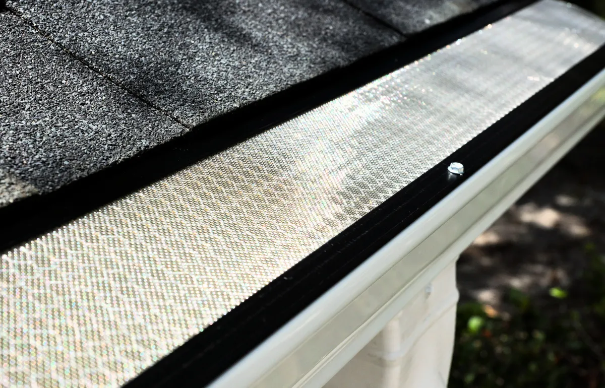 Installed Clean Gutter Protection guard system on a home, preventing debris from entering and clogging the gutter.