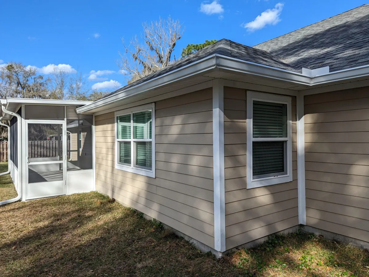 House with newly installed gutters, showcasing Clean Gutter Protection's professional installation and lifetime warranty coverage.