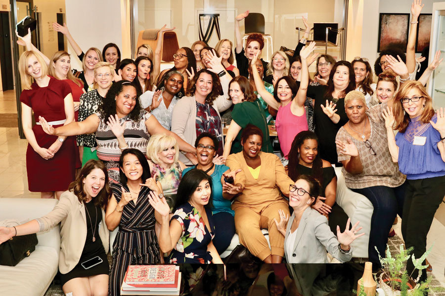 a red gift box with a gold bow on a black background with red hearts