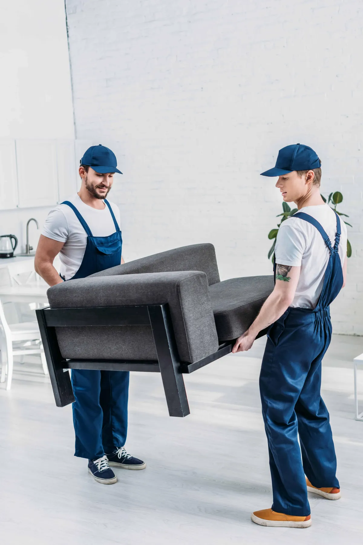 Movers moving furniture in an apartment