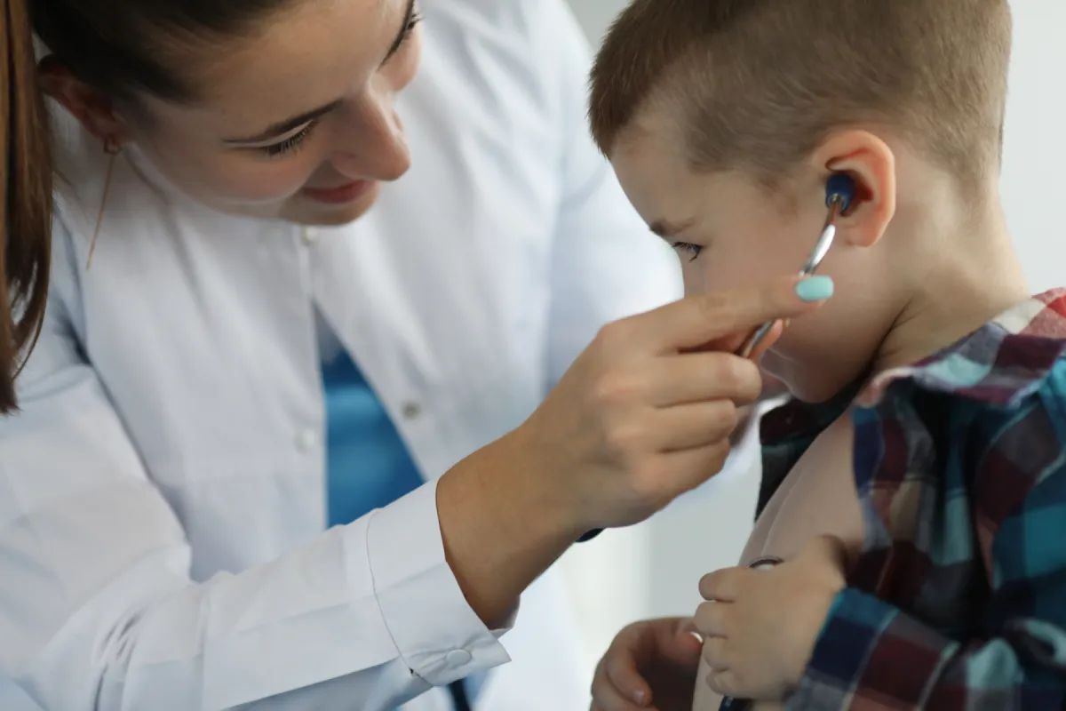Ocala family doctor examining a young child's ear at Elite Medical Direct Primary Care