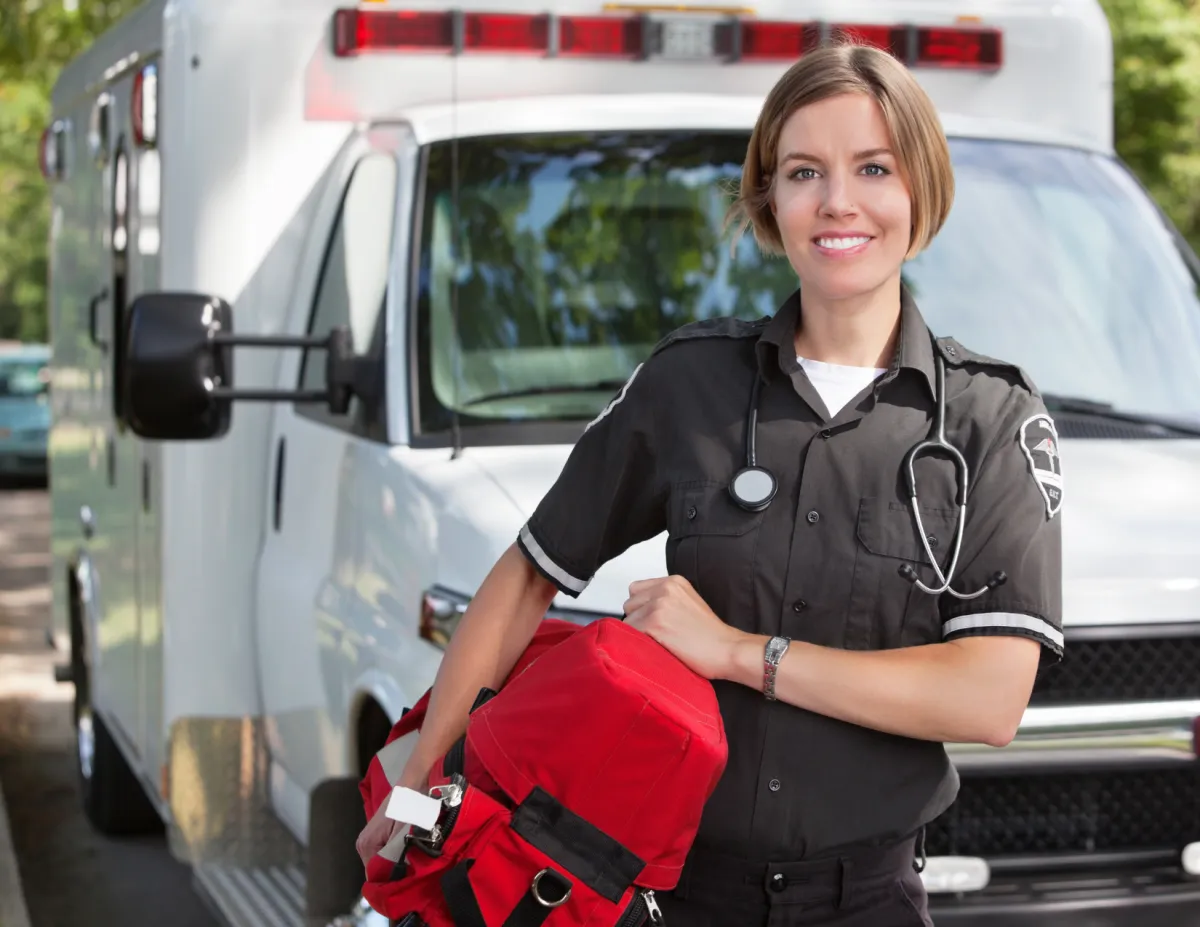 A female paramedic holding a medical bag in front of an ambulance in Ocala, Florida