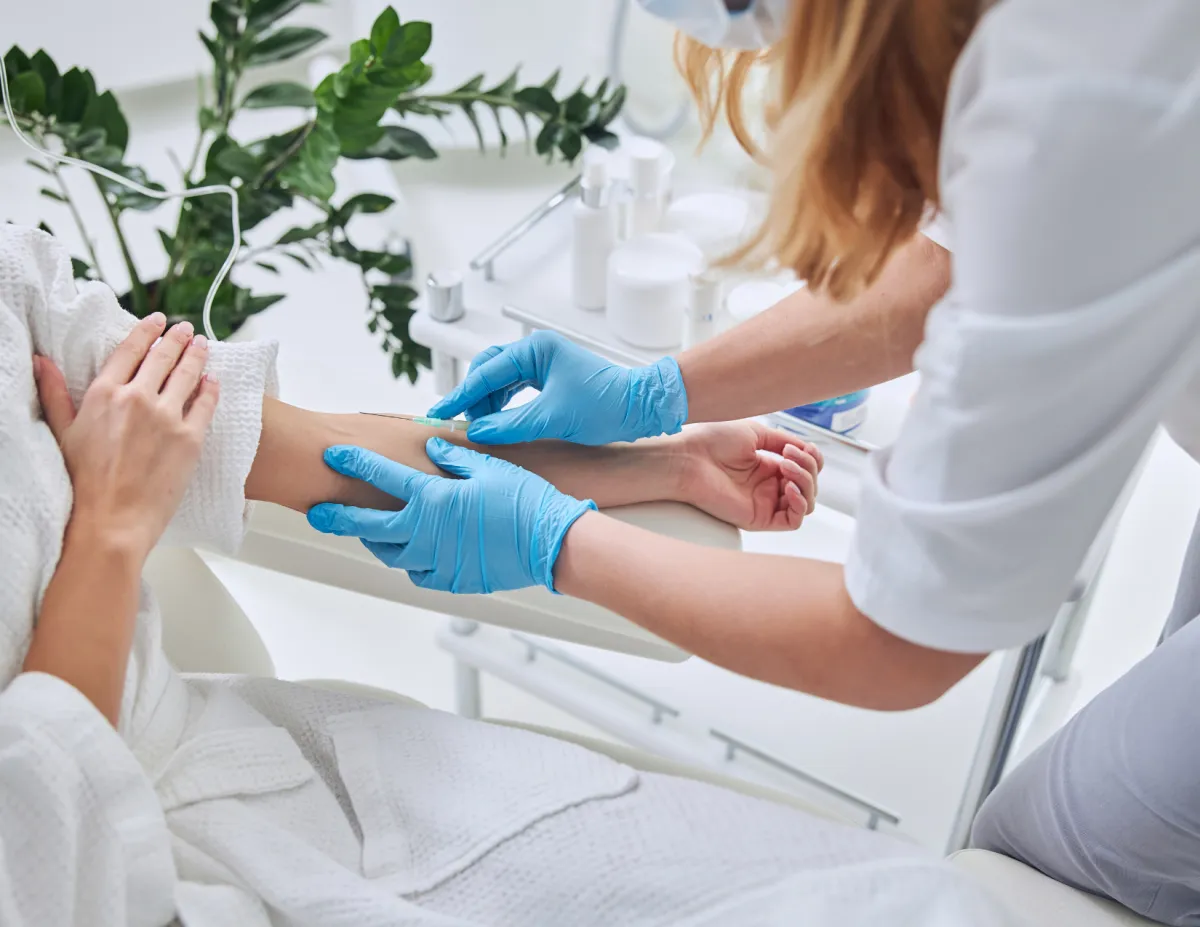 Medical professional administering IV infusion therapy at Elite Medical Ocala