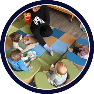 Daycare classroom play activity with toddlers, promoting early childhood development and guided learning