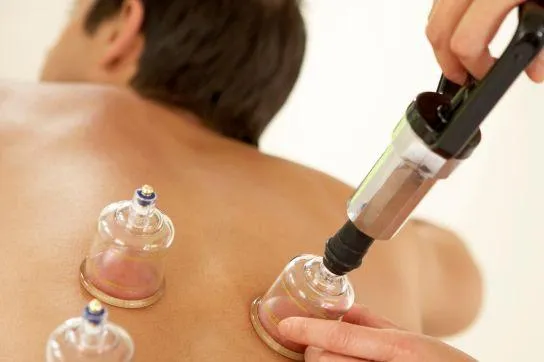 Gua Sha treatment using smooth scraping tool to reduce inflammation and boost circulation