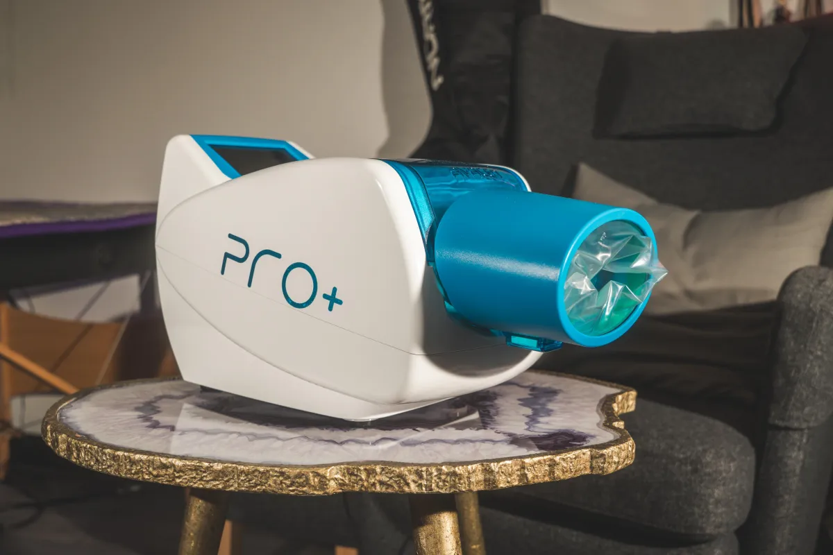 Close-up of AVACEN therapy unit delivering heat and pressure therapy to the palm