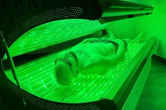 ARRC LED light therapy bed emitting red, green, and infrared wavelengths for cellular healing