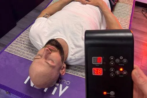 Client using inHarmony Sound Lounge for vibroacoustic therapy and stress reduction