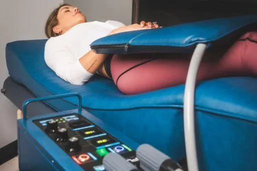 Client lying on PEMF therapy mat for cellular recovery and energy restoration