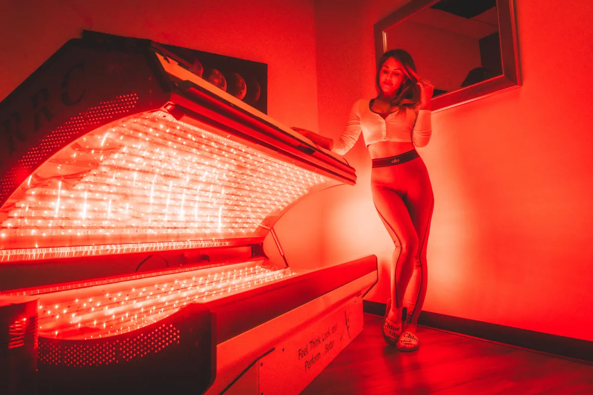 Client receiving full-body ARRC LED light therapy for muscle recovery and inflammation