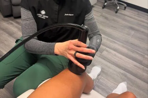 OmniWave acoustic wave therapy device used for deep tissue pain relief and mobility enhancement