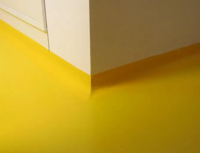Smooth yellow epoxy coating along wall baseboards from Epoxy Flooring Service in Albury, NSW specialists.