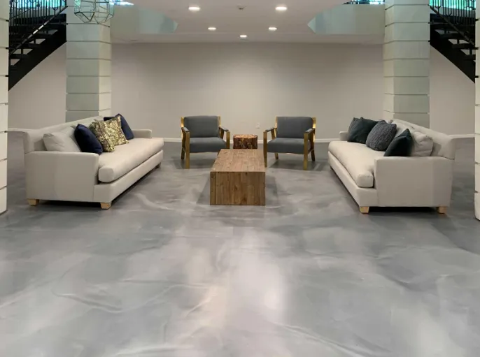 Modern living room with glossy gray epoxy floor installed by Epoxy Flooring Service in Albury, NSW, with lasting appeal.