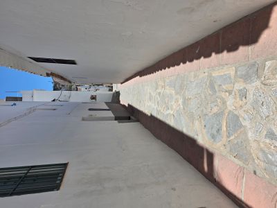 Narrow street in Spain with whitewashed walls — a reminder that sometimes we have to slow down and trust the path ahead