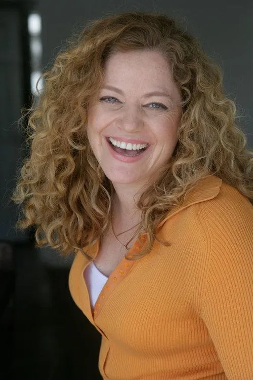a woman standing on a bridge with her arms crossed