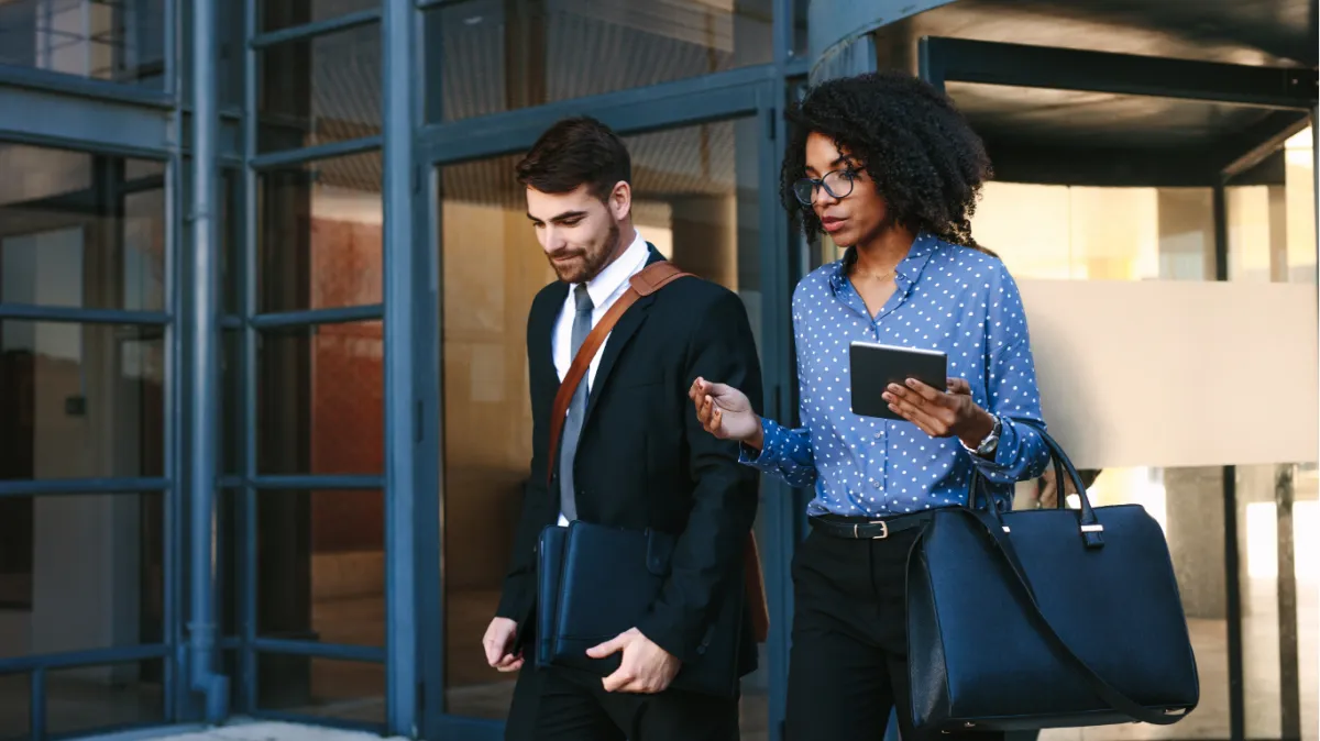 Executives walk out of building talking