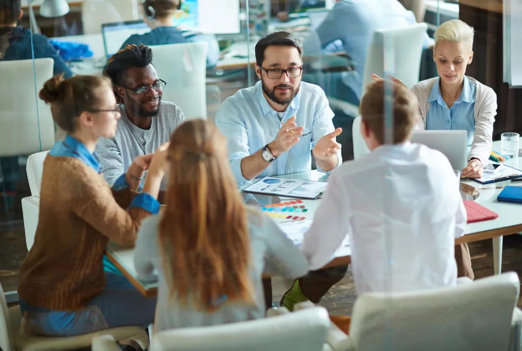 Employees gathered around a table