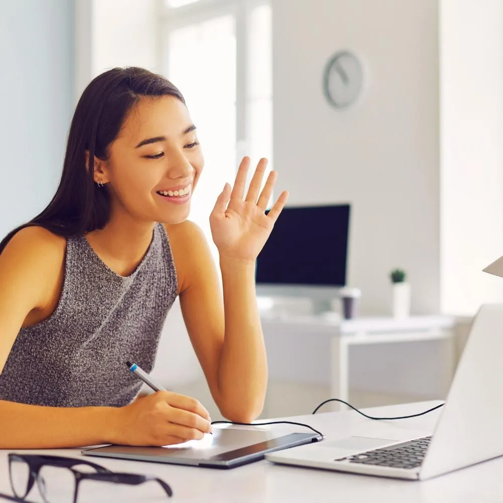 young pretty girl smiling and listening to a course of her laptop