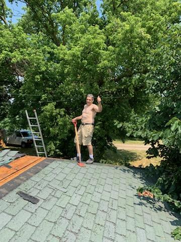 Before-and-after shingle replacement on a suburban bungalow highlighting new architectural shingles and ridge vents.