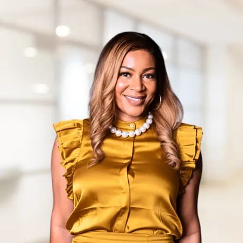 A confident female entrepreneur, mid-30s, waist-up portrait in warm natural light inside a home office with soft plants in the background, smart-casual attire, photographic style highlighting leadership, faith-forward professionalism, and approachability.