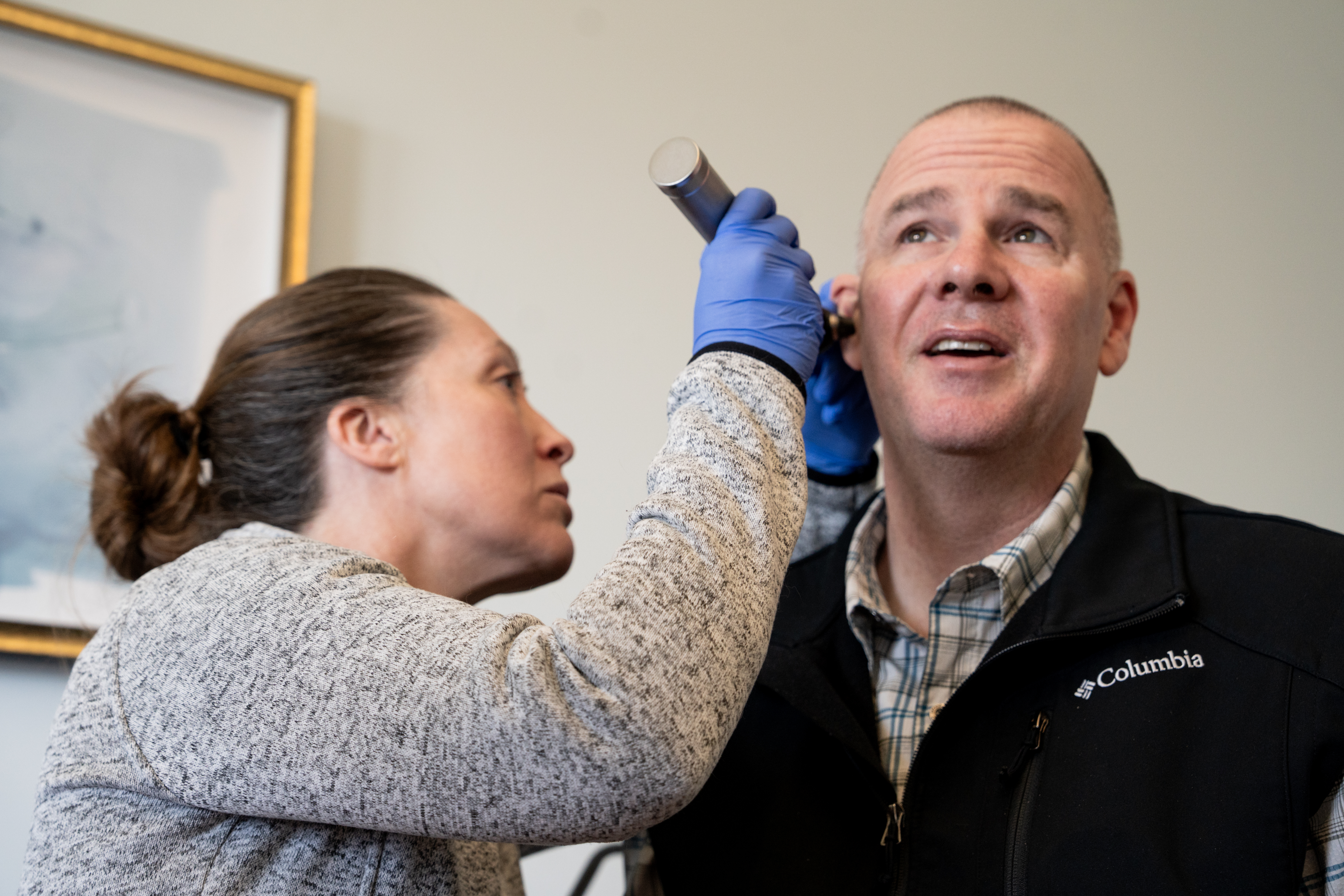 A doctor and patient having a relaxed conversation in a medical office