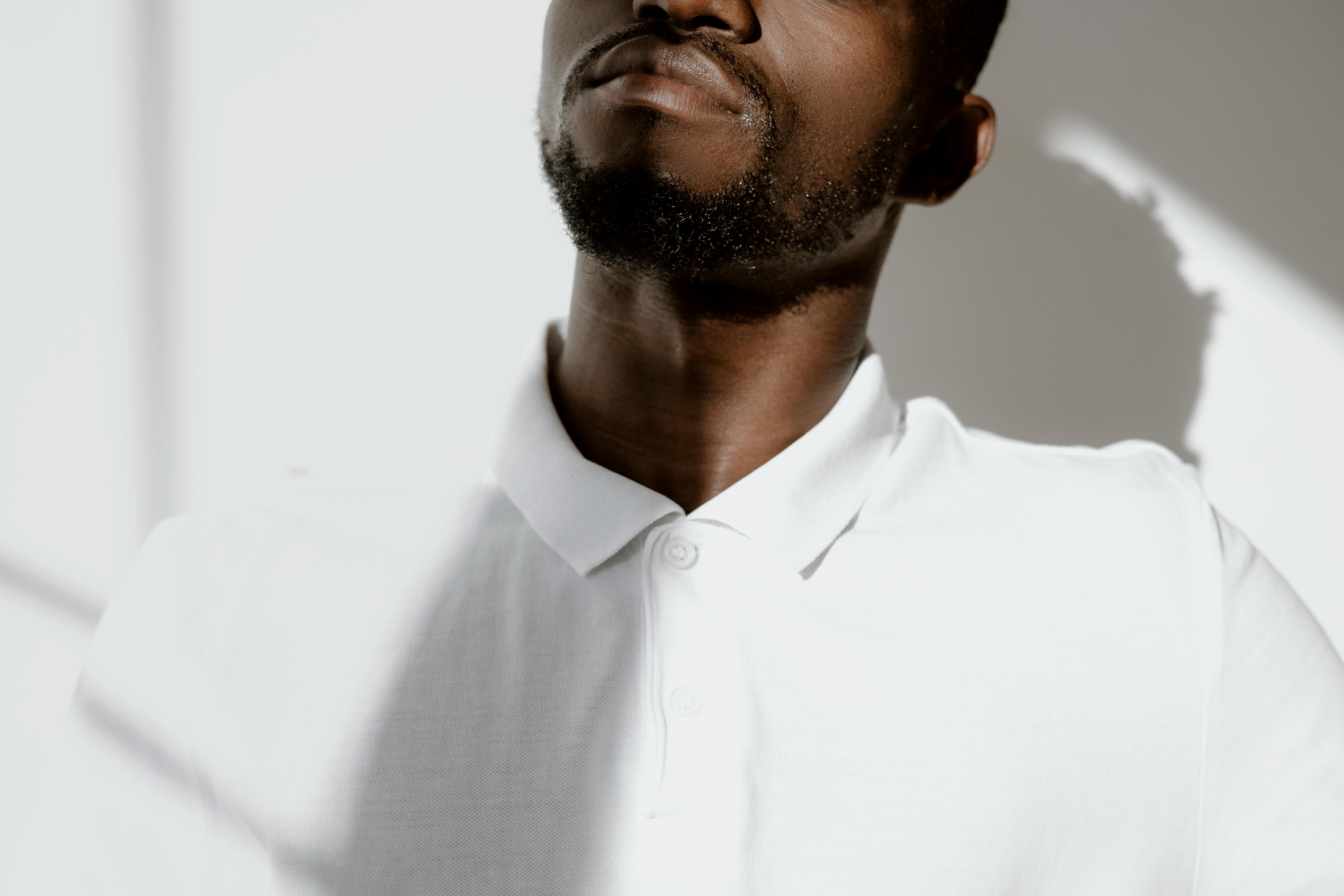 Close-up of a man’s lower face highlighting natural lips and jawline, representing subtle lip enhancement and facial balance for men