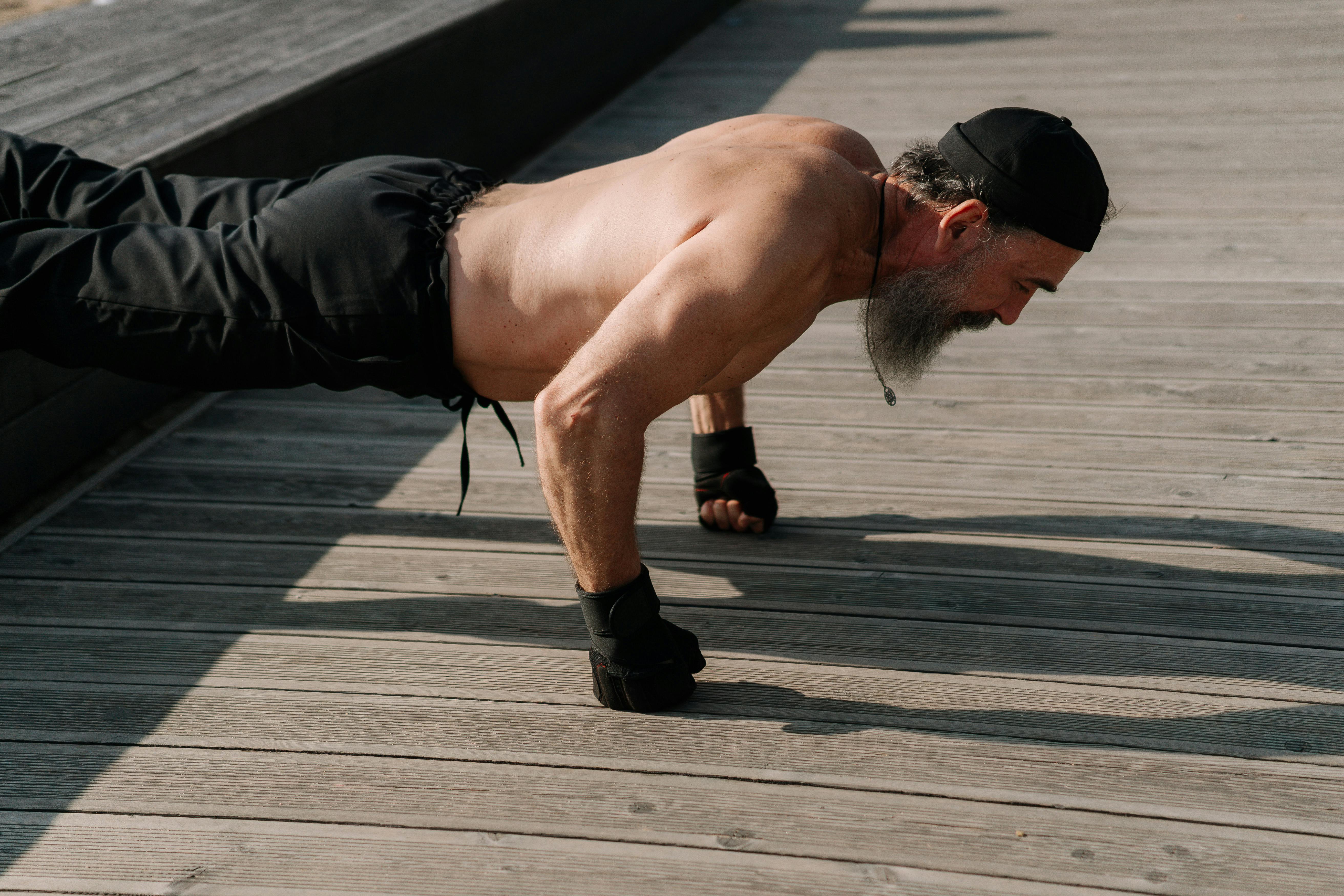 Fit middle-aged man doing push-ups outdoors, representing strength, vitality, and healthy testosterone levels in men